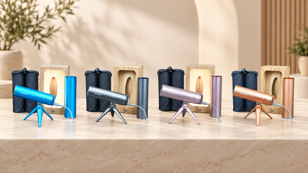 The LeLunar HandsFreeDryer kit in Bondi Blue, Space Grey, Sunset Rose and Amber Gold: dryer, folding tripod, wall mount and travel capsule, on a marble counter